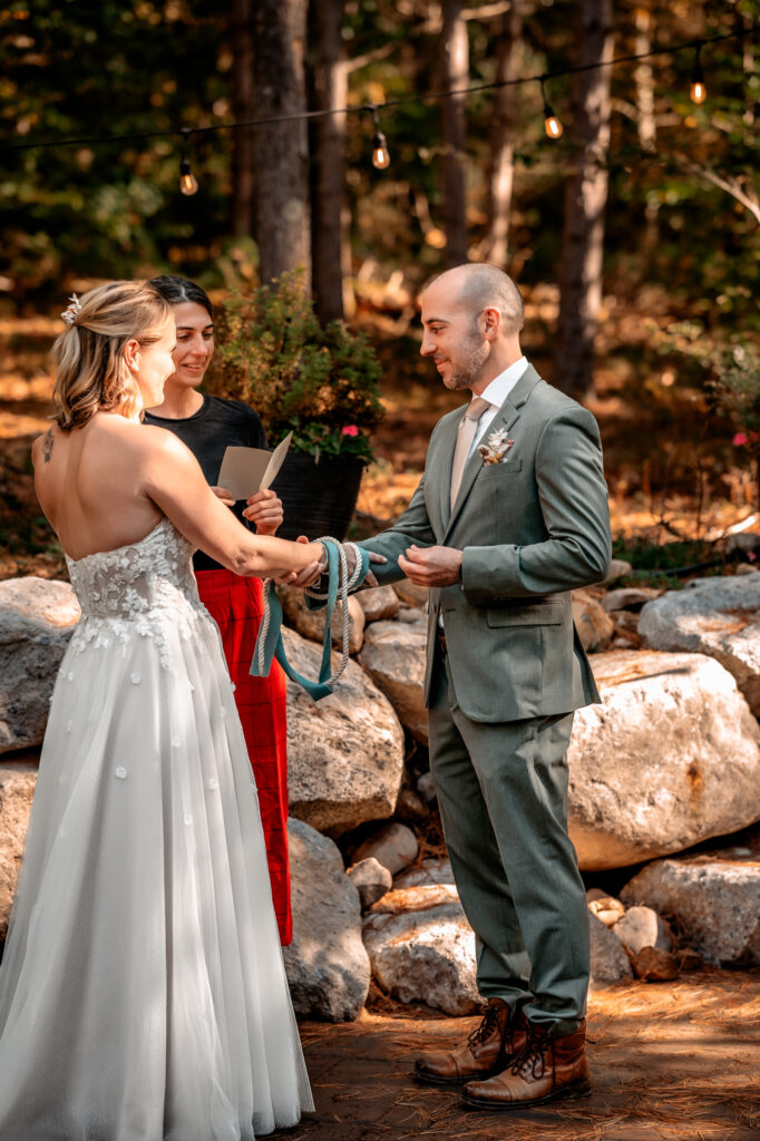 knot tying ceremony with bride and groom and officiant