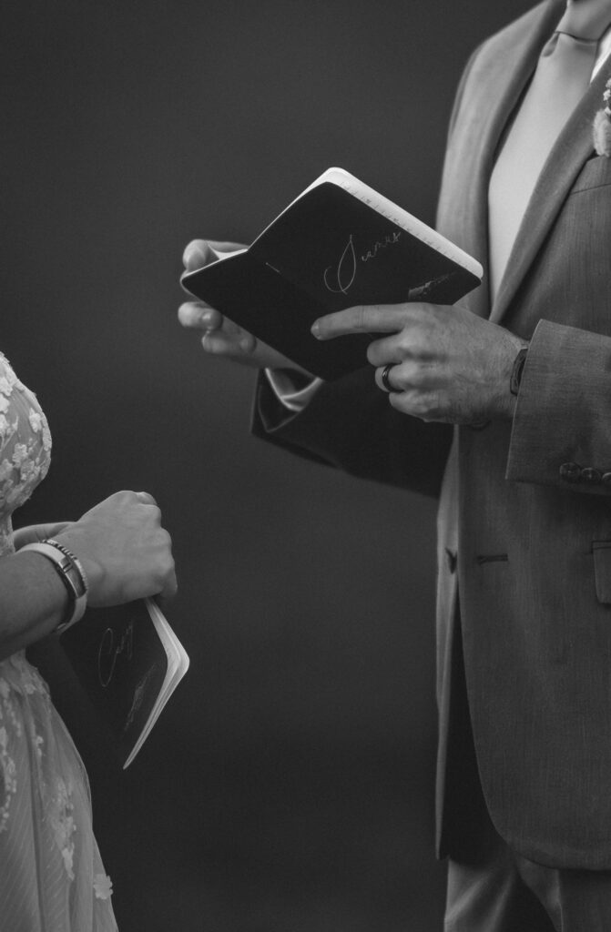 vow book and hands in black and white
