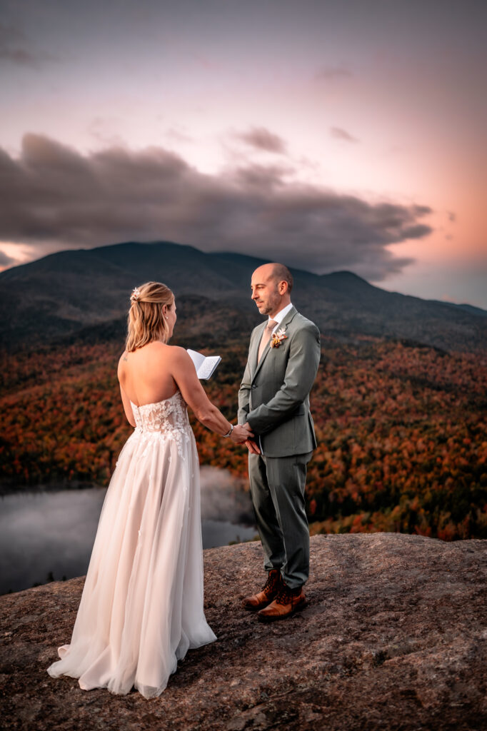 Bride shares vows to groom on mountain in fall.