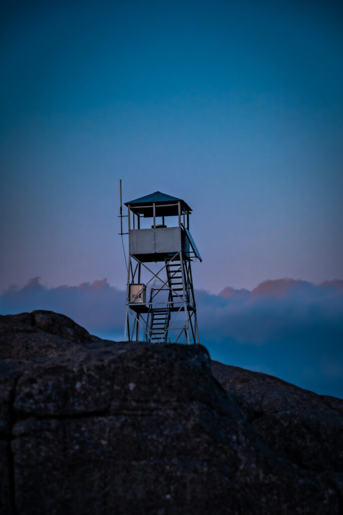A fire tower at sunset on hurricane mountain, a crowd free location to elope in the adirondacks
