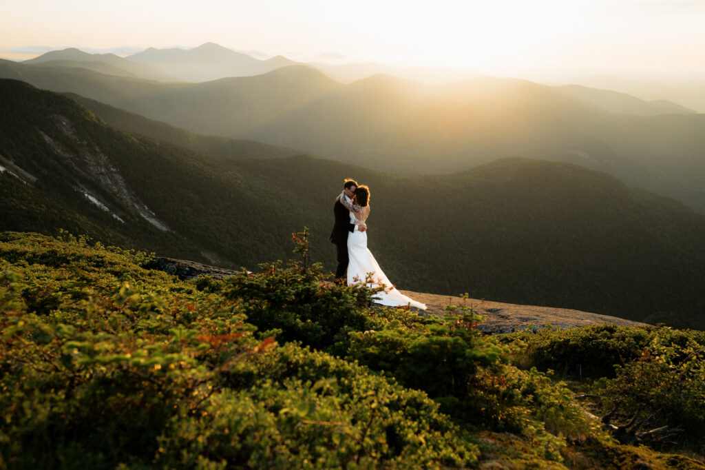 A couple has their first dance on top of an Adirondack High Peak at sunset. 
