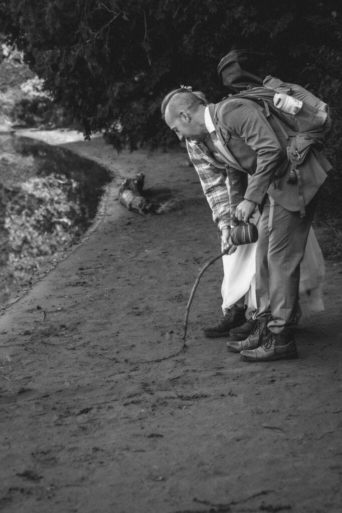 bride and groom draw their initials in the sand
