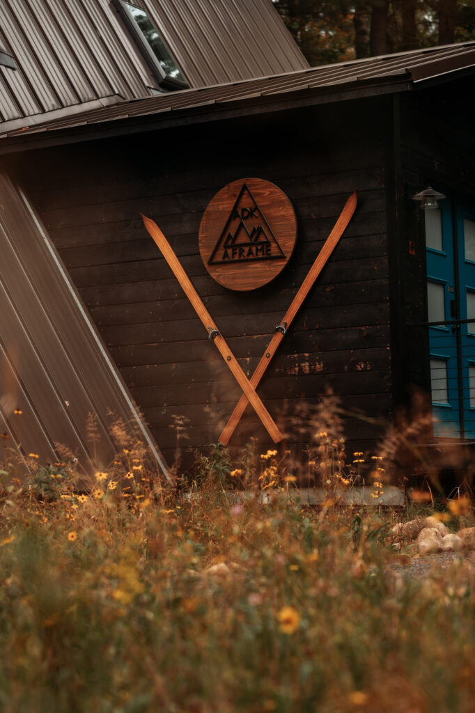 Adk A frame with skis and sign. 