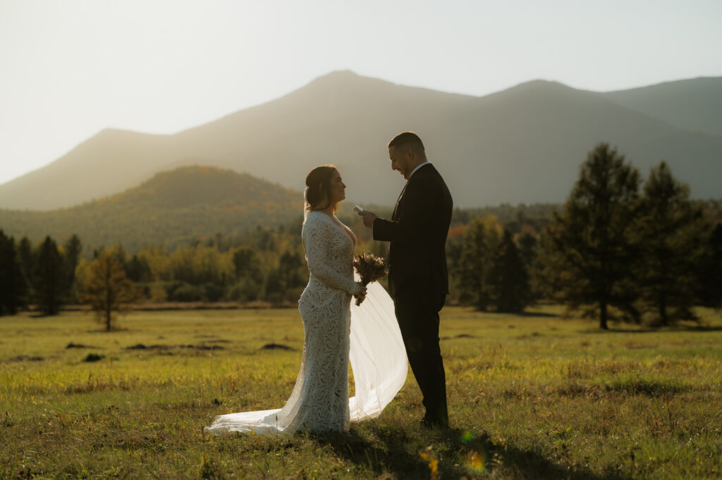 Couple says i do in a field in the adirondack mountains at sunset