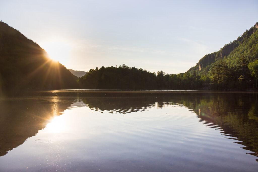 A pond in the adirondack mountains at sunset.
