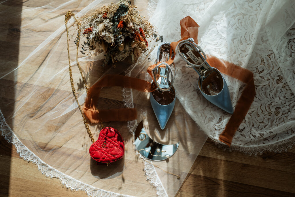 Wedding accessories flat lay with sun peaking in.