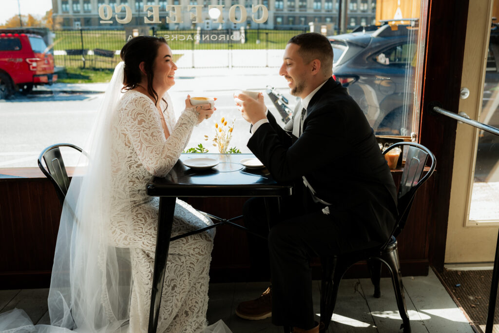 Couple shares coffee in lake placid new york on their elopement day