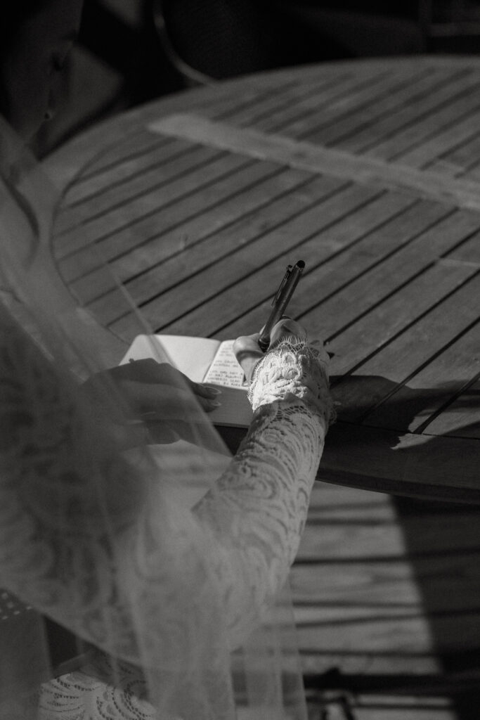 Bride writing vows on a deck at an air bnb in the adirondacks.