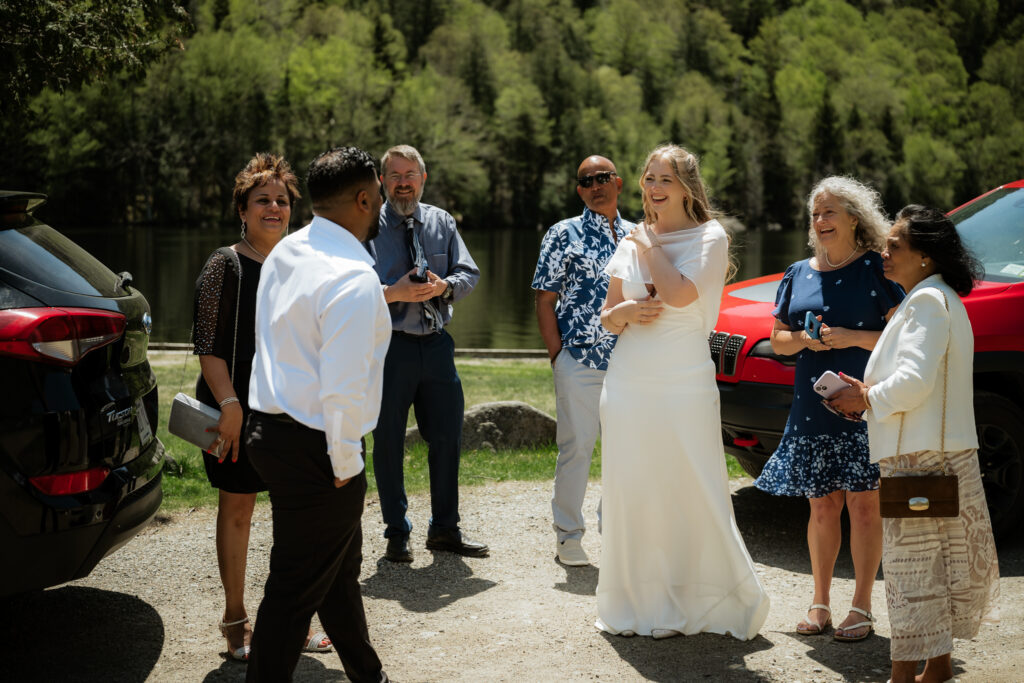 Married couple gathers with family in parking lot 