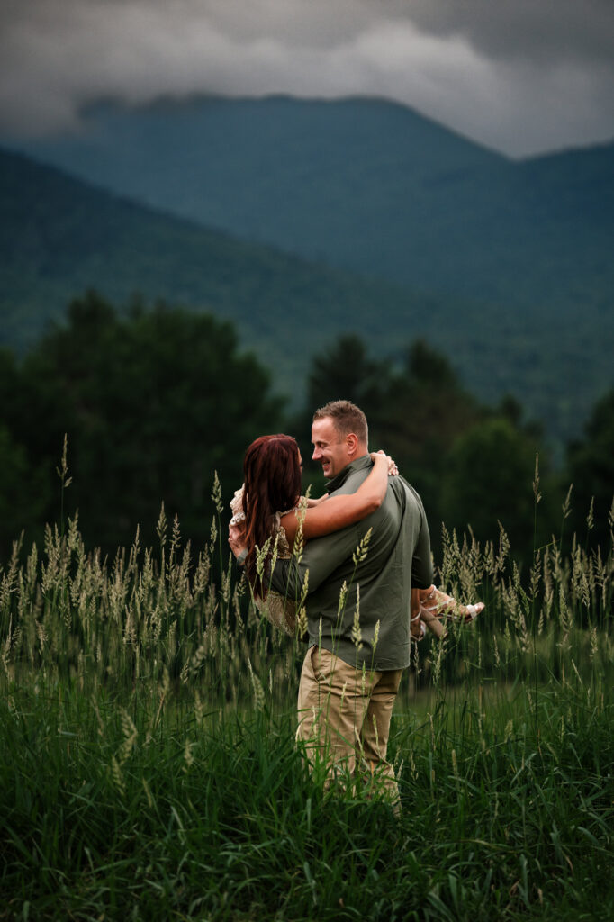 A summer elopement in a field of tall grass on a moody and cloudy spring day.