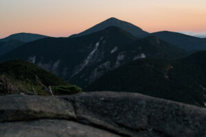 A picture of the adirondack high peaks at sunset with rock faces.